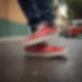 A classic pair of red Vans skater shoes on a skateboard