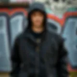 A stylish black anorak jacket against a graffiti backdrop