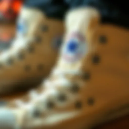 A close-up view of cream Chuck Taylor high tops showcasing their design details.