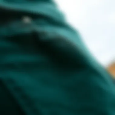 Close-up of the fabric and texture of dark green wide leg jeans