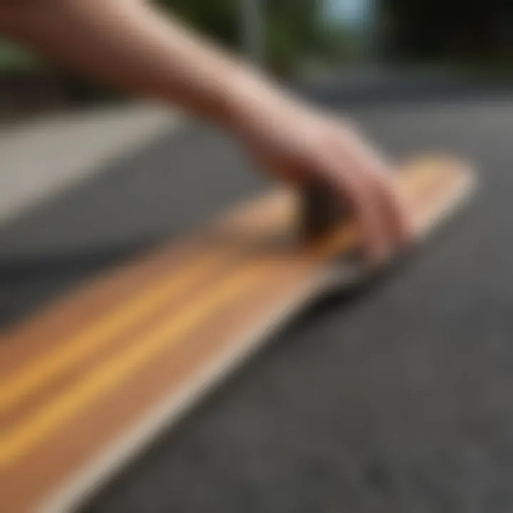 A longboard deck being carefully taped with new grip material