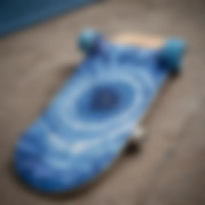 An artistic representation of a blue tie dye t-shirt laid out on a skateboard deck.