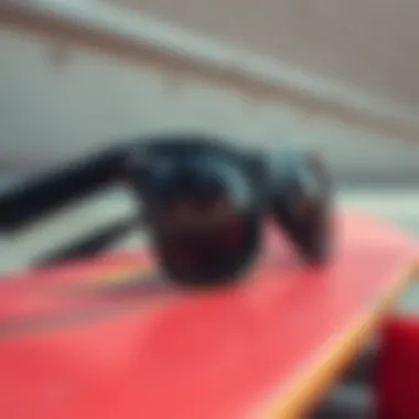 Close-up of stylish black sunglasses resting on a skateboard