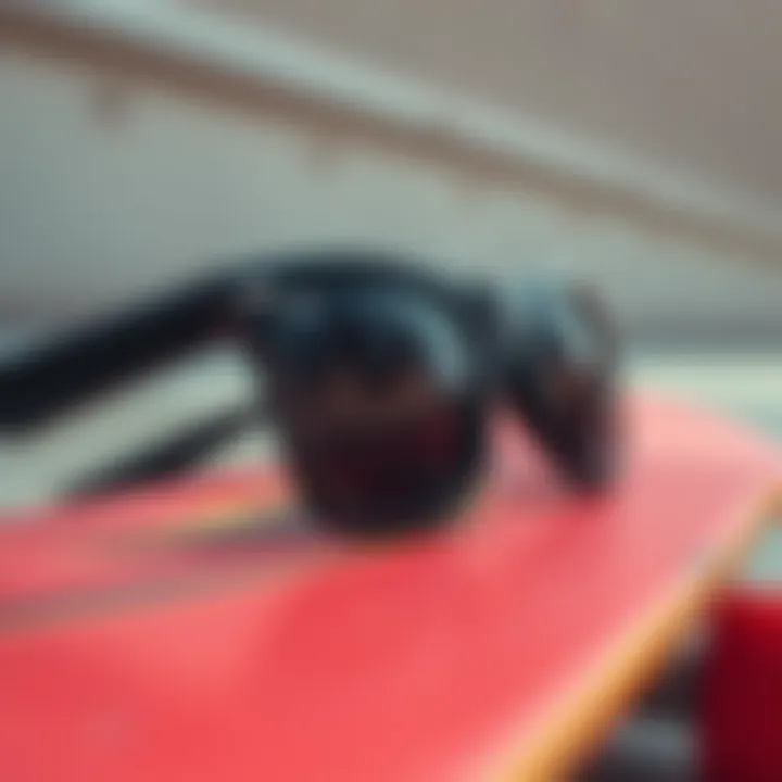 Close-up of stylish black sunglasses resting on a skateboard