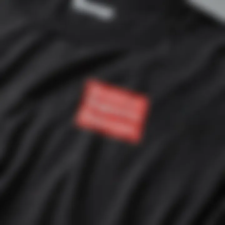 Close-up of the Supreme logo on a black t-shirt