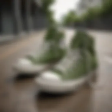 A pair of army green Converse low tops on a skateboard