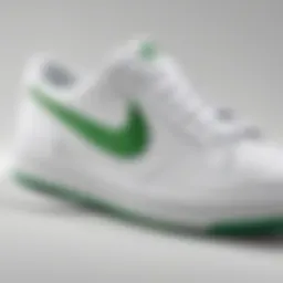 Close-up of the green swoosh design on the white Nike sneakers