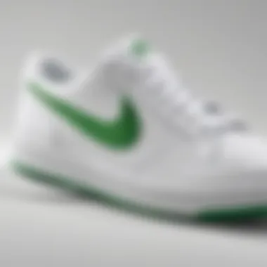 Close-up of the green swoosh design on the white Nike sneakers